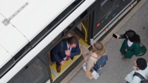 Passengers waiting at an ajman bus stop platform